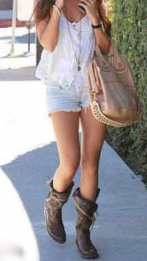 Modern hippie girl in denim shorts and boots